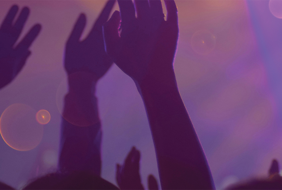 Crowd at concert with purple lighting