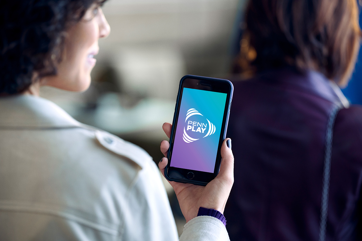 Woman on PENN Play app on mobile phone