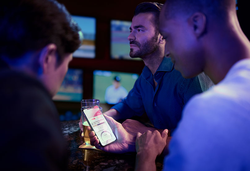 person on their phone at bar